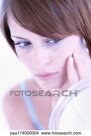 Woman with fingers on cheek, close up View Large Photo Image Picture - Woman with fingers on cheek, close up. Fotosearch