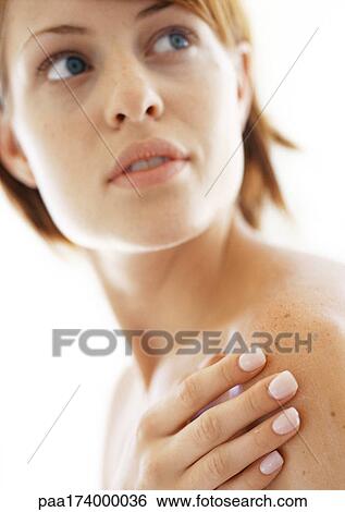 Stock Photograph - Woman with hand on shoulder, close-up. Fotosearch