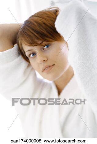 Stock Photo - Woman with hands behind head, portrait, close-up. Fotosearch