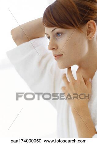 Woman with one hand behind head and other under chin View Large Photo Image Stock Image - Woman with one hand behind head and other under chin. Fotosearch