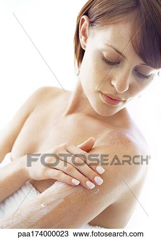 Young woman applying moisturizer to arm, close-up View Large Photo Image Stock Image - Young woman applying moisturizer to arm, close-up. Fotosearch