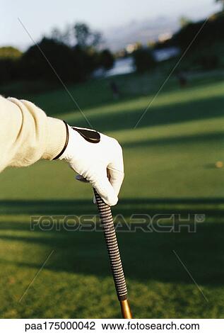 Stock Image - Hand on golf club, close-up. Fotosearch