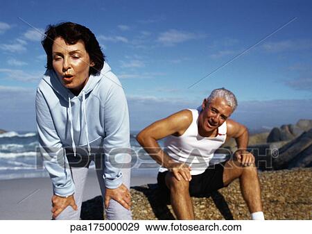 Mature couple in sportswear, resting View Large Photo Image Stock Photo - Mature couple in sportswear, resting. Fotosearch