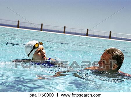 Mature man and woman in swimming pool View Large Photo Image Stock Image - Mature man and woman in swimming pool. Fotosearch