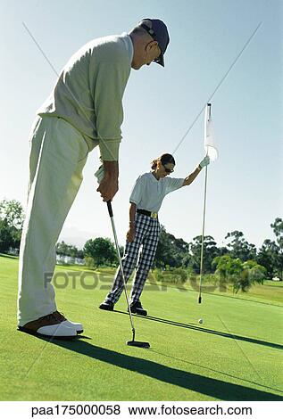 Mature man putting, woman holding flag View Large Photo Image Stock Photo - Mature man putting, woman holding flag. Fotosearch