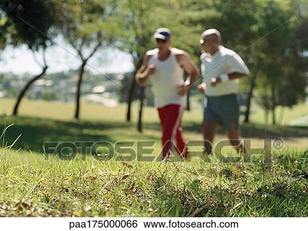 Two joggers in park, blurred View Large Photo Image Stock Photograph - Two joggers in park, blurred. Fotosearch