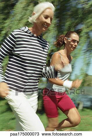 Two joggers in park View Large Photo Image Stock Image - Two joggers in park. Fotosearch