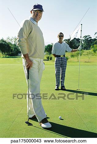 Two mature golfers on green, portrait View Large Photo Image Stock Image - Two mature golfers on green, portrait. Fotosearch