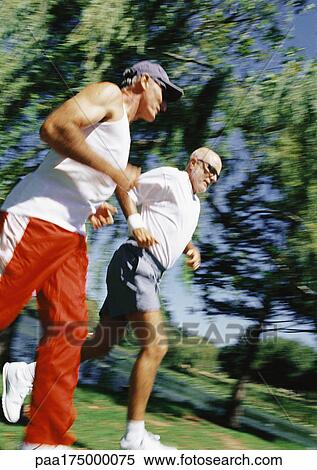 Two mature joggers in park, low angle view View Large Photo Image Stock Photography - Two mature joggers in park, low angle view. Fotosearch