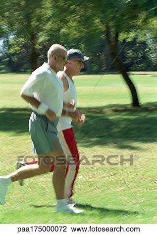 Two mature joggers in park, side view View Large Photo Image Stock Image - Two mature joggers in park, side view. Fotosearch