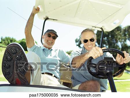 Two mature men in golf cart, smiling, close-up View Large Photo Image Stock Photography - Two mature men in golf cart, smiling, close-up. Fotosearch