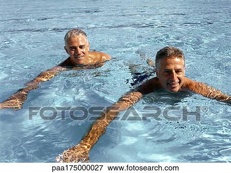 Two mature men in swimming pool, smiling View Large Photo Image Stock Photo - Two mature men in swimming pool, smiling. Fotosearch