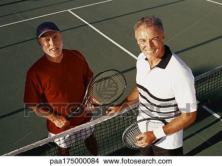 Two mature men on tennis court, portrait View Large Photo Image Picture - Two mature men on tennis court, portrait. Fotosearch
