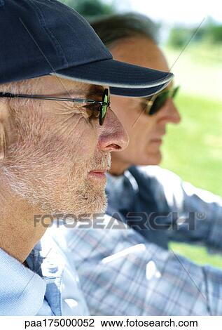 Two mature men wearing sunglasses, close-up, side view View Large Photo Image Stock Image - Two mature men wearing sunglasses, close-up, side view. Fotosearch