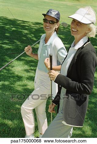 Two mature women with golf clubs, portrait View Large Photo Image Stock Photo - Two mature women with golf clubs, portrait. Fotosearch