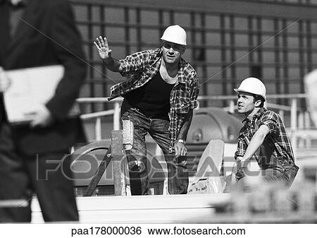 Builders with hard hats, talking, b&w View Large Photo Image Stock Photograph - Builders with hard hats, talking, b&w. Fotosearch