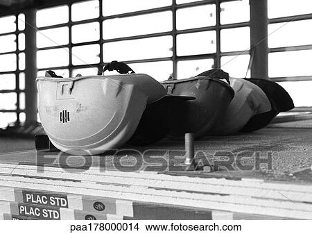 Hard hats lined up, b&w View Large Photo Image Picture - Hard hats lined up, b&w. Fotosearch