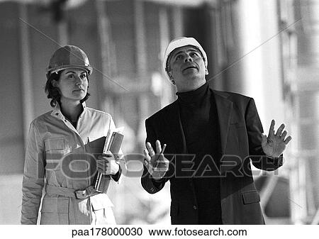 Man and woman wearing hard hats, b&w View Large Photo Image Stock Image - Man and woman wearing hard hats, b&w. Fotosearch