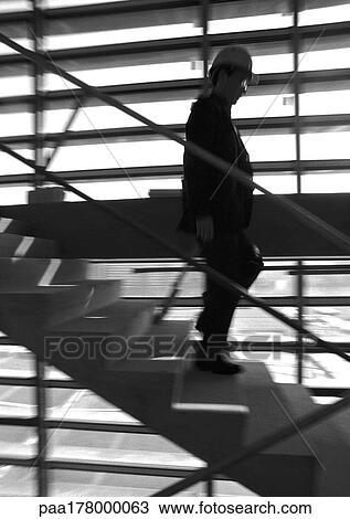 Man on stairs, wearing hard hat, blurred motion, b&w View Large Photo Image Stock Image - Man on stairs, wearing hard hat, blurred motion, b&w. Fotosearch