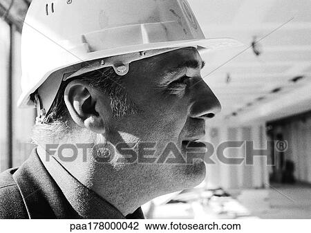 Man wearing hard hat, side view, close-up, b&w View Large Photo Image Stock Image - Man wearing hard hat, side view, close-up, b&w. Fotosearch