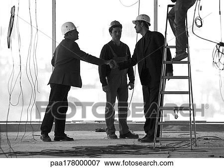 Men wearing hard hats, shaking hands View Large Photo Image Stock Photo - Men wearing hard hats, shaking hands. Fotosearch