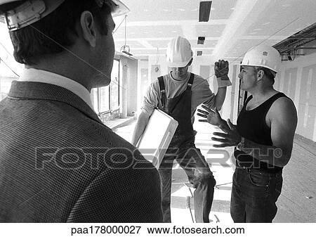 Men wearing hard hats, talking, b&w View Large Photo Image Stock Photo - Men wearing hard hats, talking, b&w. Fotosearch