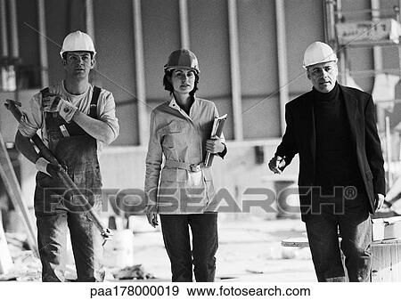 Two men and woman wearing hard hats, b&w View Large Photo Image Stock Photo - Two men and woman wearing hard hats, b&w. Fotosearch