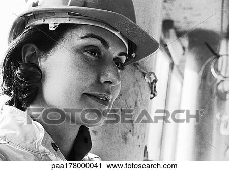 Woman wearing hard hat, close-up, b&w View Large Photo Image Stock Image - Woman wearing hard hat, close-up, b&w. Fotosearch
