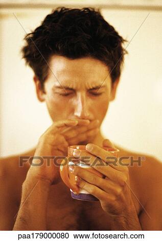 Bare-chested man holding mug and yawning, covering mouth with hand View Large Photo Image Stock Image - Bare-chested man holding mug and yawning, covering mouth with hand. Fotosearch