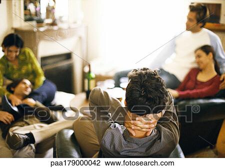 Five young people sitting in living room View Large Photo Image Stock Image - Five young people sitting in living room. Fotosearch