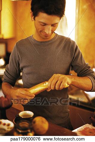 Man breaking bread View Large Photo Image Stock Photograph - Man breaking bread. Fotosearch