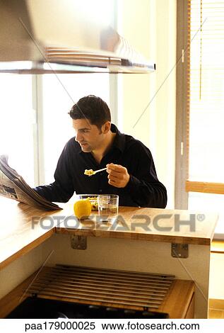 Man eating and reading newspaper View Large Photo Image Stock Photography - Man eating and reading newspaper. Fotosearch