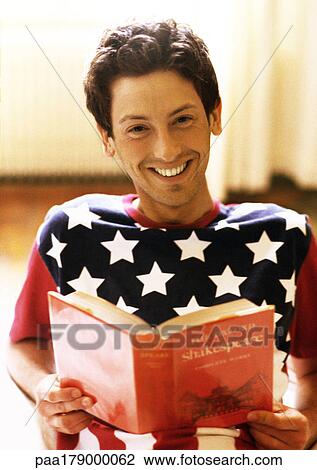 Man holding book, smiling, portrait View Large Photo Image Stock Image - Man holding book, smiling, portrait. Fotosearch