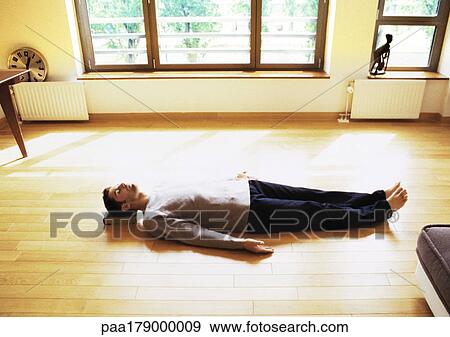 Man lying on floor View Large Photo Image Stock Photo - Man lying on floor. Fotosearch