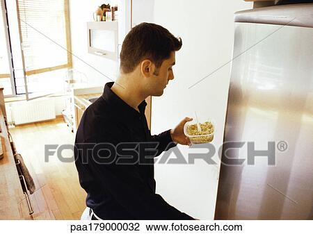Man putting food in refrigerator View Large Photo Image Stock Image - Man putting food in refrigerator. Fotosearch