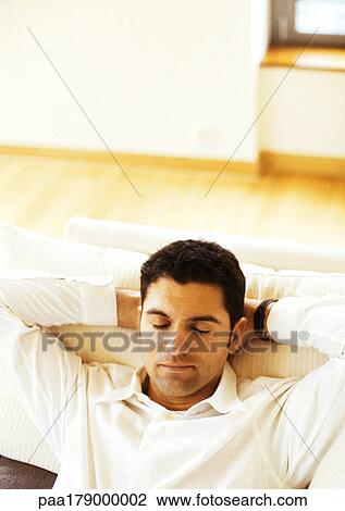 Man resting on sofa, close-up View Large Photo Image Stock Image - Man resting on sofa, close-up. Fotosearch