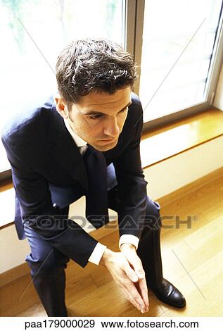 Man sitting in front of window View Large Photo Image Stock Photo - Man sitting in front of window. Fotosearch