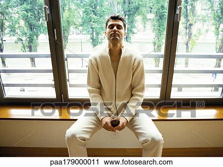 Man sitting in front of window with head back and eyes closed View Large Photo Image Stock Image - Man sitting in front of window with head back and eyes closed. Fotosearch