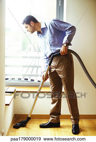 Man vacuuming View Large Photo Image Stock Photo - Man vacuuming. Fotosearch