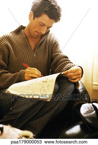 Man writing on newspaper View Large Photo Image Stock Image - Man writing on newspaper. Fotosearch