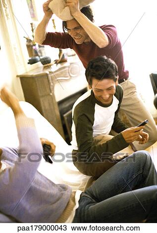 People having pillow fight in living room View Large Photo Image Stock Image - People having pillow fight in living room. Fotosearch