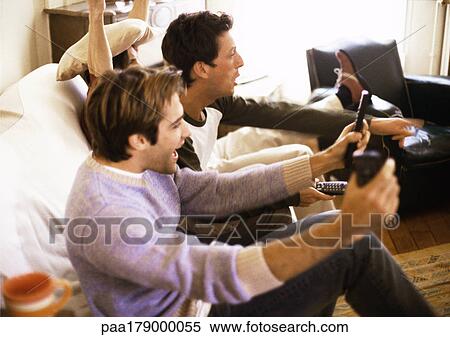 Three men sitting on sofa, gesturing, side view View Large Photo Image Stock Photography - Three men sitting on sofa, gesturing, side view. Fotosearch