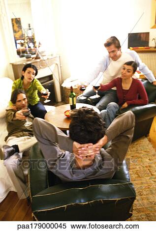 Young people sitting in living room, drinking wine View Large Photo Image Stock Photography - Young people sitting in living room, drinking wine. Fotosearch