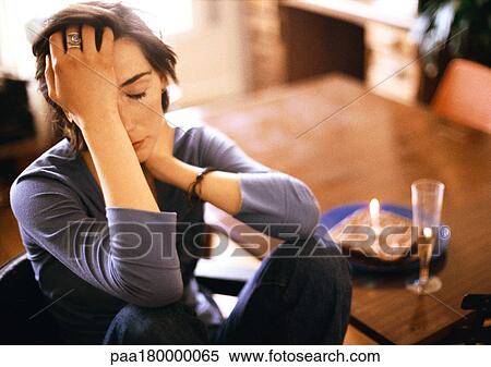 Woman at table, holding head View Large Photo Image Stock Photography - Woman at table, holding head. Fotosearch