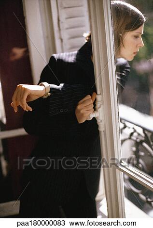 Stock Image - Woman looking out of window. Fotosearch