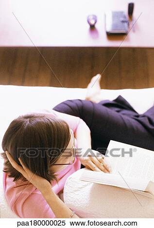 Woman lying and reading book View Large Photo Image Stock Photography - Woman lying and reading book. Fotosearch