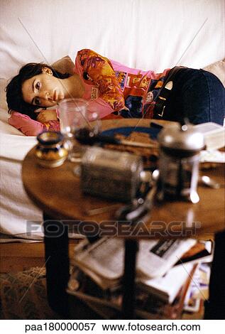 Woman lying on sofa, blurred View Large Photo Image Stock Photo - Woman lying on sofa, blurred. Fotosearch