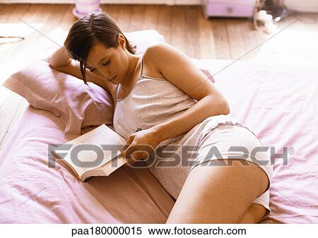 Woman reading on bed View Large Photo Image Stock Photography - Woman reading on bed. Fotosearch