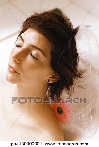Woman taking bath, close-up of head resting on plastic pillow View Large Photo Image Stock Image - Woman taking bath, close-up of head resting on plastic pillow. Fotosearch