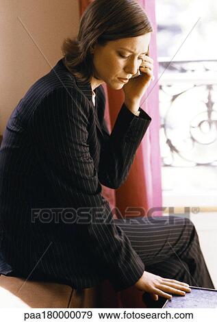 Stock Photo - Woman using cell phone, looking down. Fotosearch